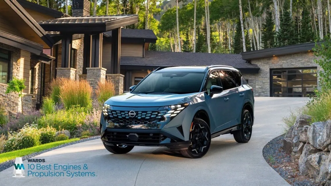 Nissan Rogue on driveway - Saffarazzi Nissan Rogue compact SUV front three-quarter view on driveway.