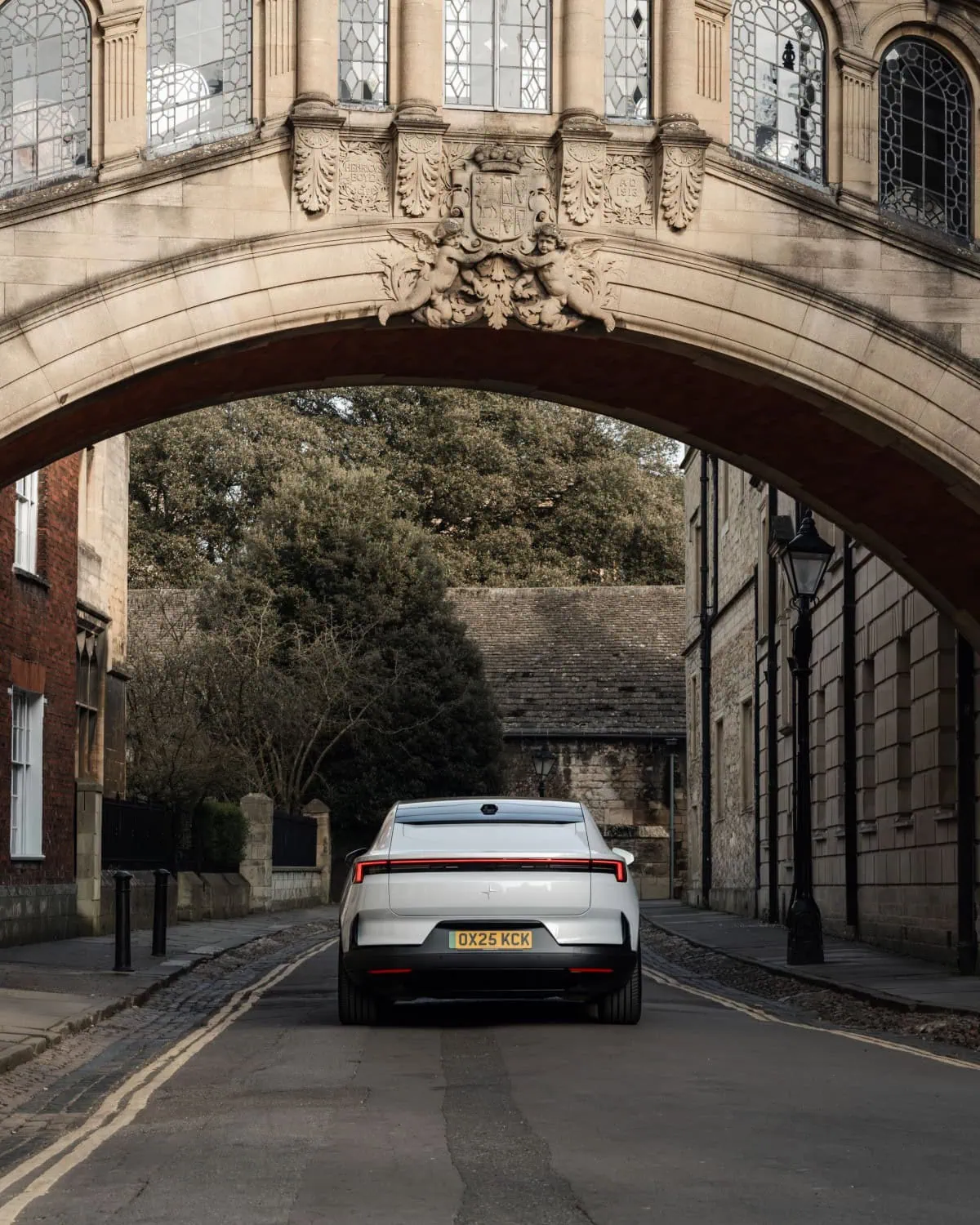 Polestar 4 under arched bridge - Saffarazzi Polestar 4 rear view beneath an Oxford stone bridge.