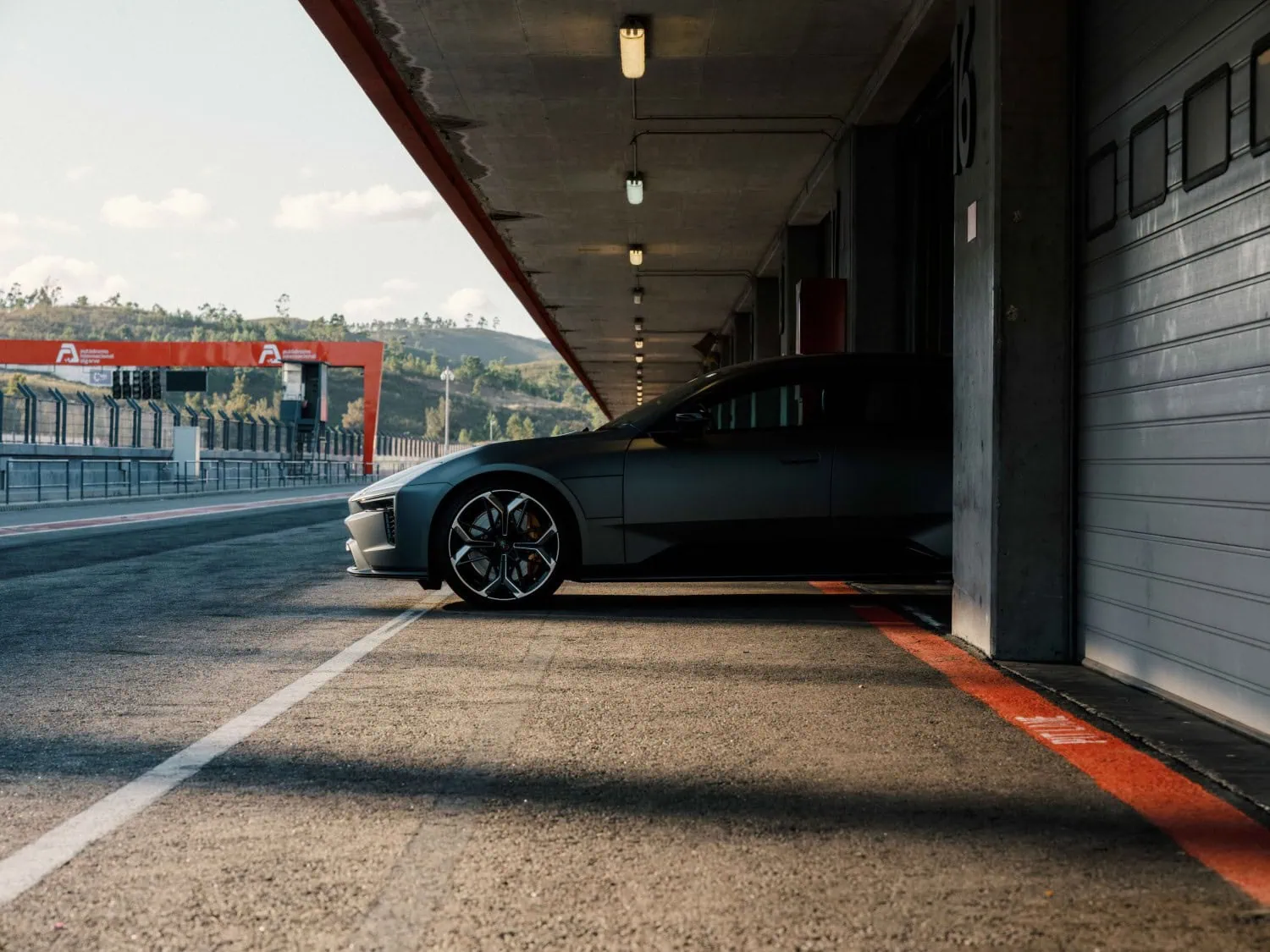 Polestar grand tourer in pit lane - Saffarazzi Polestar electric grand tourer parked in a pit garage.