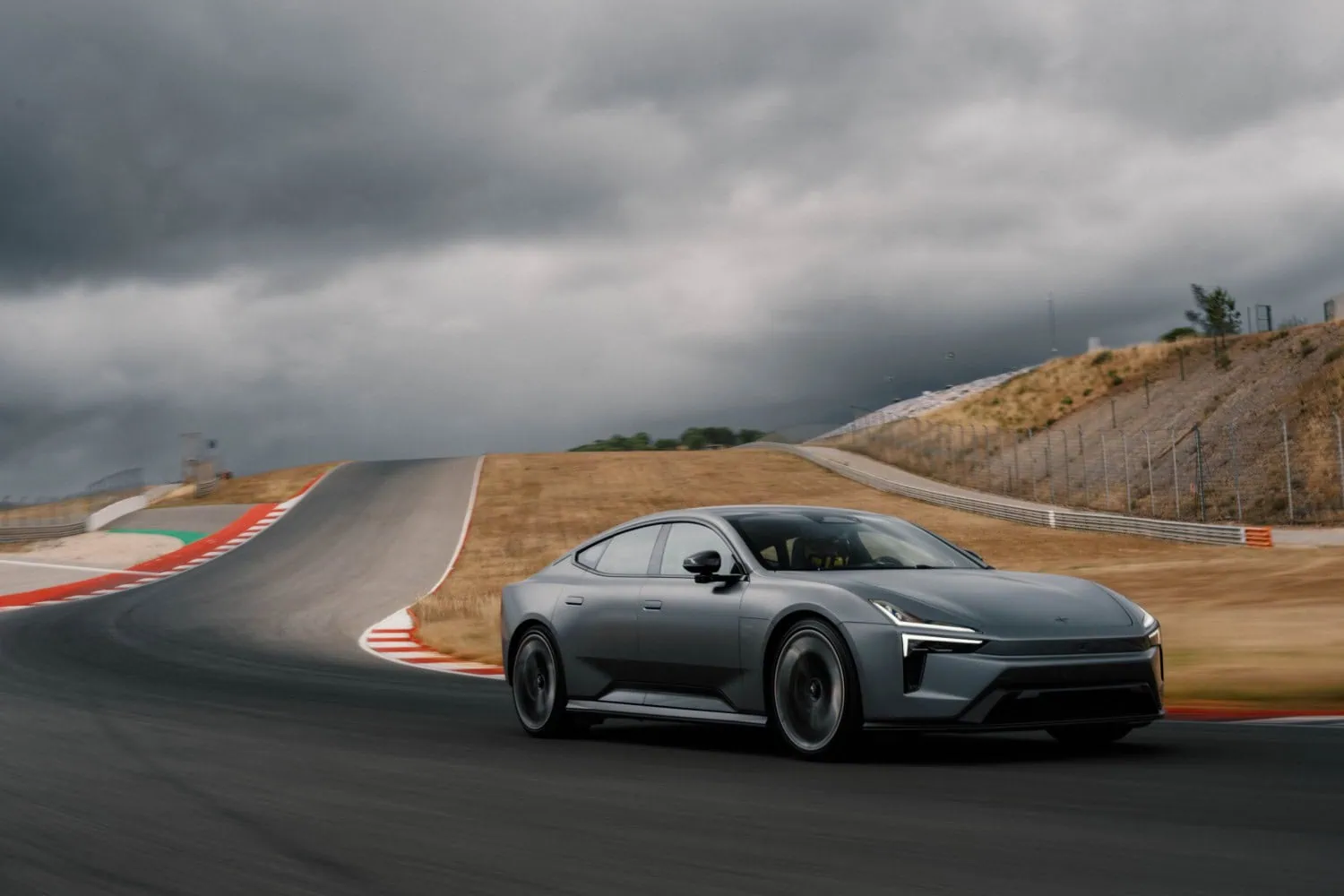 Polestar grand tourer on circuit - Saffarazzi Polestar grey electric grand tourer cornering on a race track.