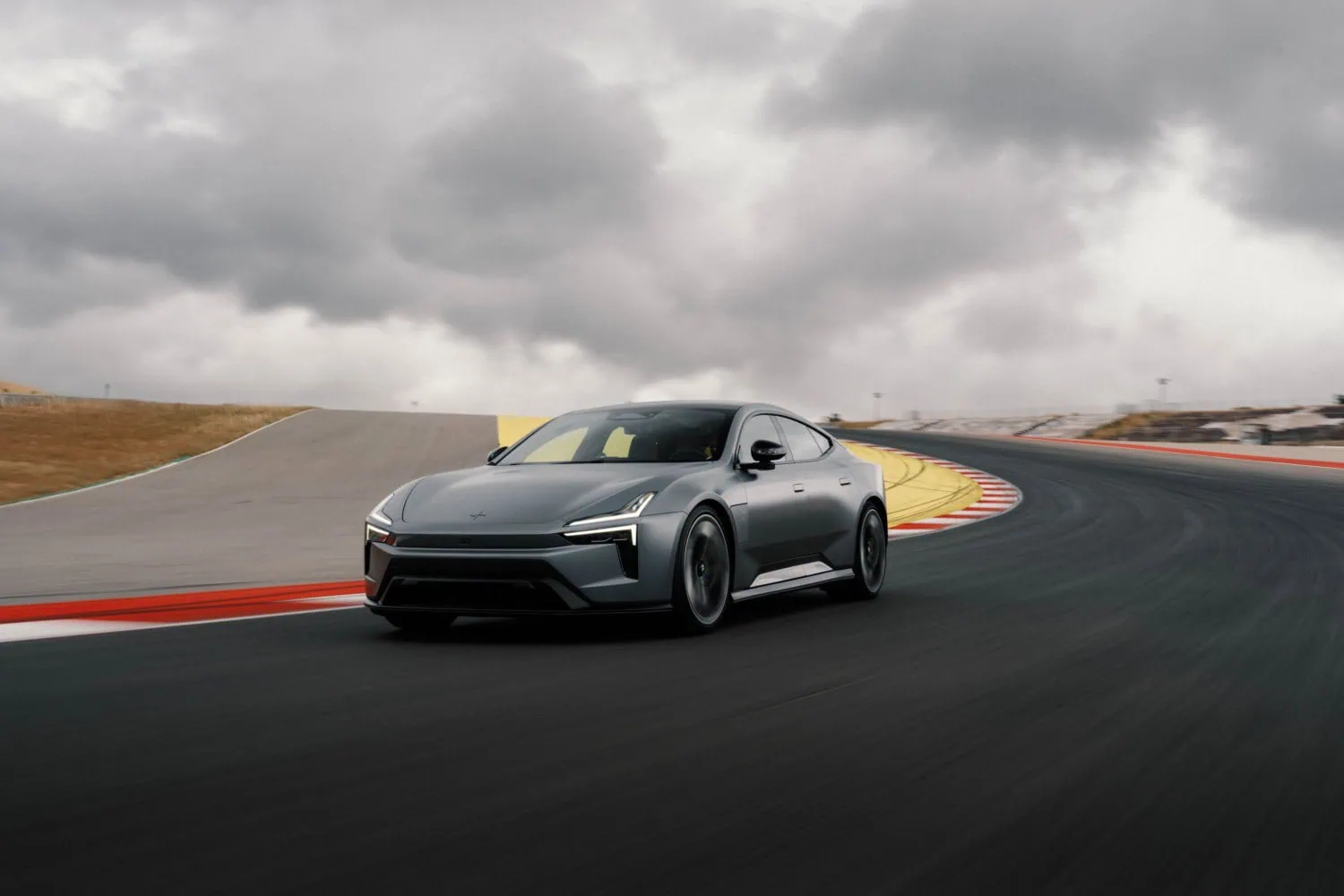 Polestar grand tourer at speed - Saffarazzi Polestar grey electric grand tourer front view on track.