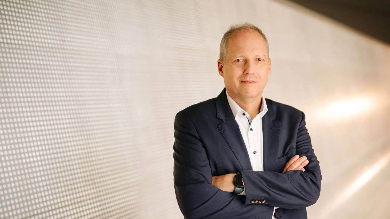 Executive with crossed arms - Saffarazzi Porsche Technologies executive with folded arms in portrait.