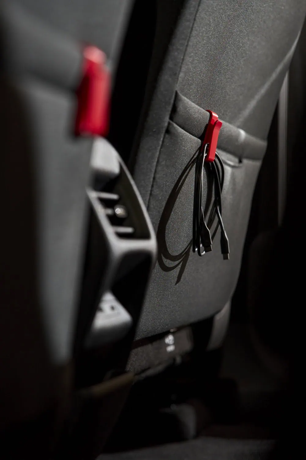 Seatback cable hook - Saffarazzi Red 3D-printed Škoda hook holding cables on seatback.