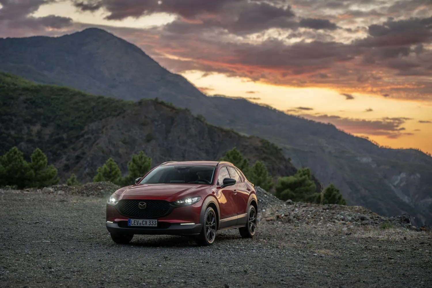 Red Mazda CX-30 front three-quarter view at sunset - Saffarazzi Red Mazda CX-30 front three-quarter view at sunset