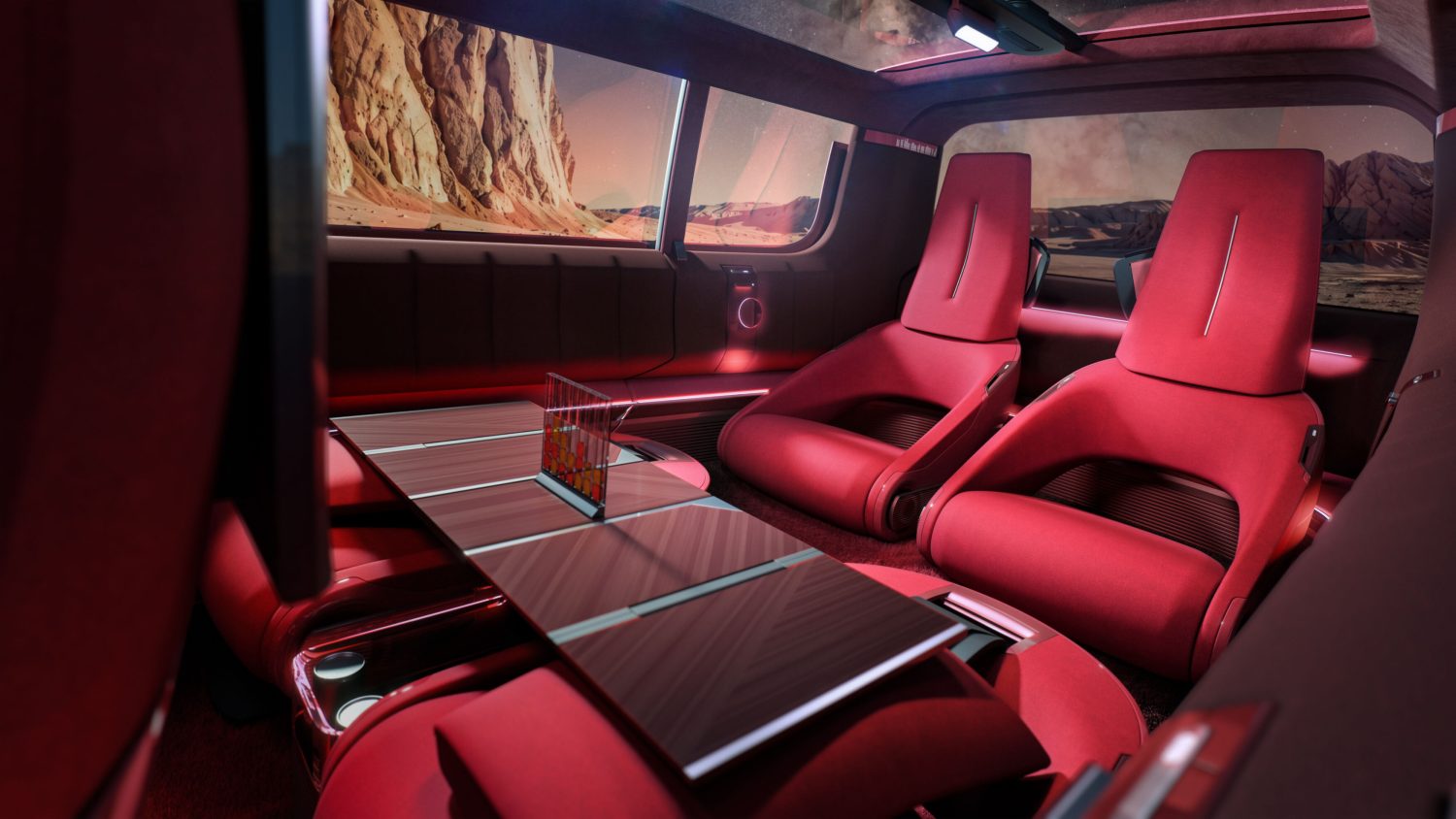 Renault E-Space Concept cabin with table and seats - Saffarazzi Luxurious red car interior with reclining seats, a wooden table, and pink ambient lighting, desert landscape visible through windows