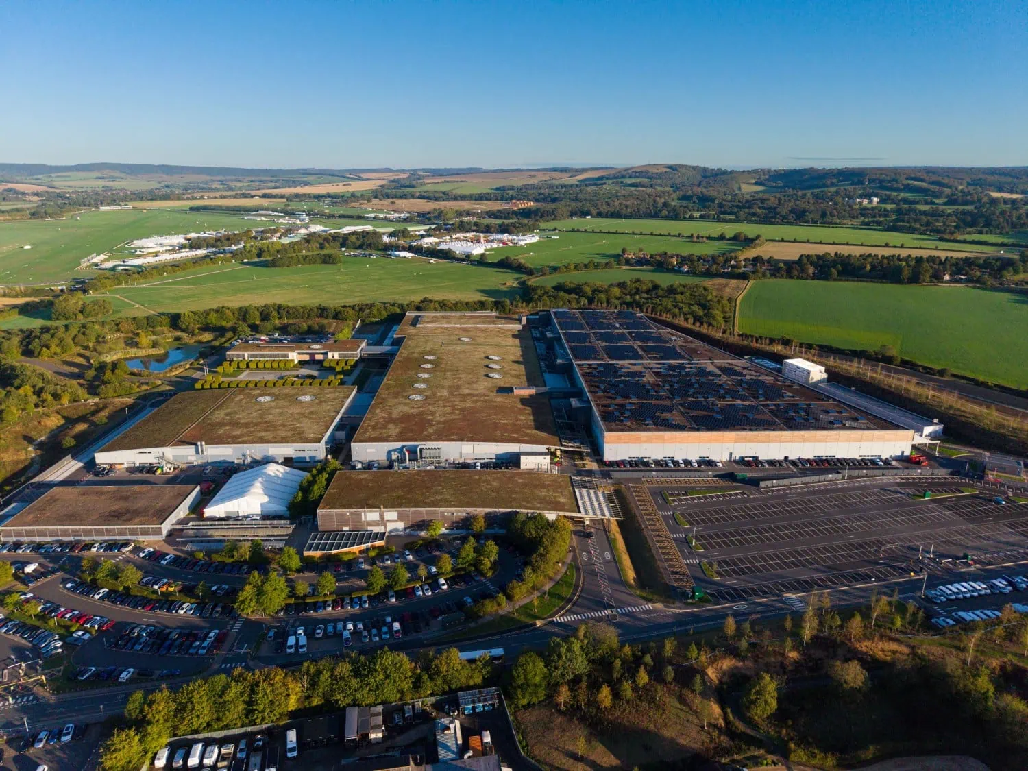 Goodwood plant in daylight - Saffarazzi Rolls-Royce Goodwood plant with living roofs and solar panels.
