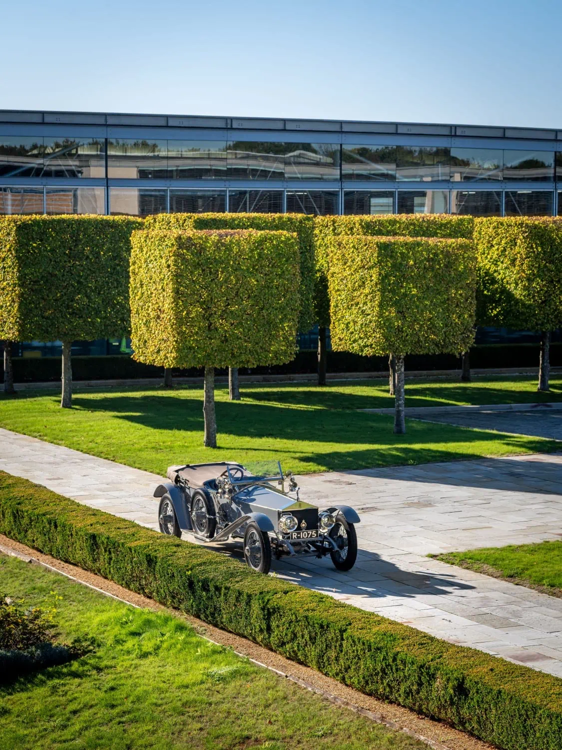 Silver Ghost among hedges - Saffarazzi Rolls-Royce Silver Ghost parked between clipped hedges.