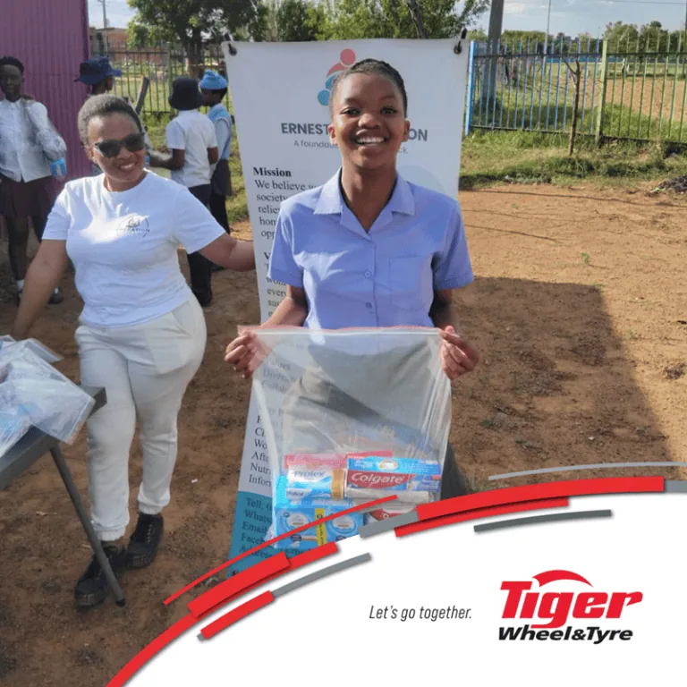 Schoolgirl holding Tiger Wheel & Tyre funded toiletry pack - Saffarazzi Schoolgirl holding Tiger Wheel & Tyre funded toiletry pack