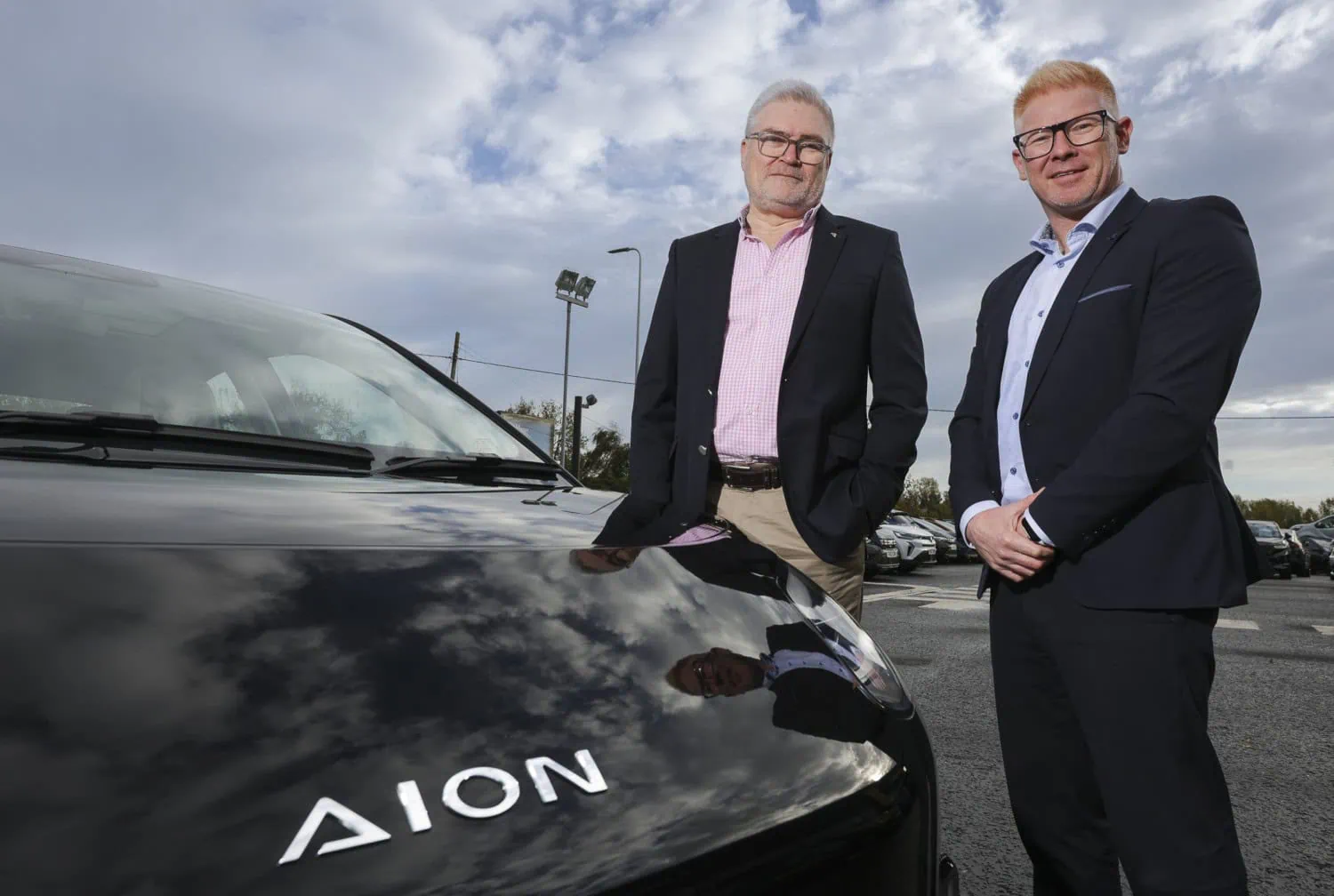 Dealer team beside AION car - Saffarazzi Shelbourne Motors representatives beside AION car bonnet.