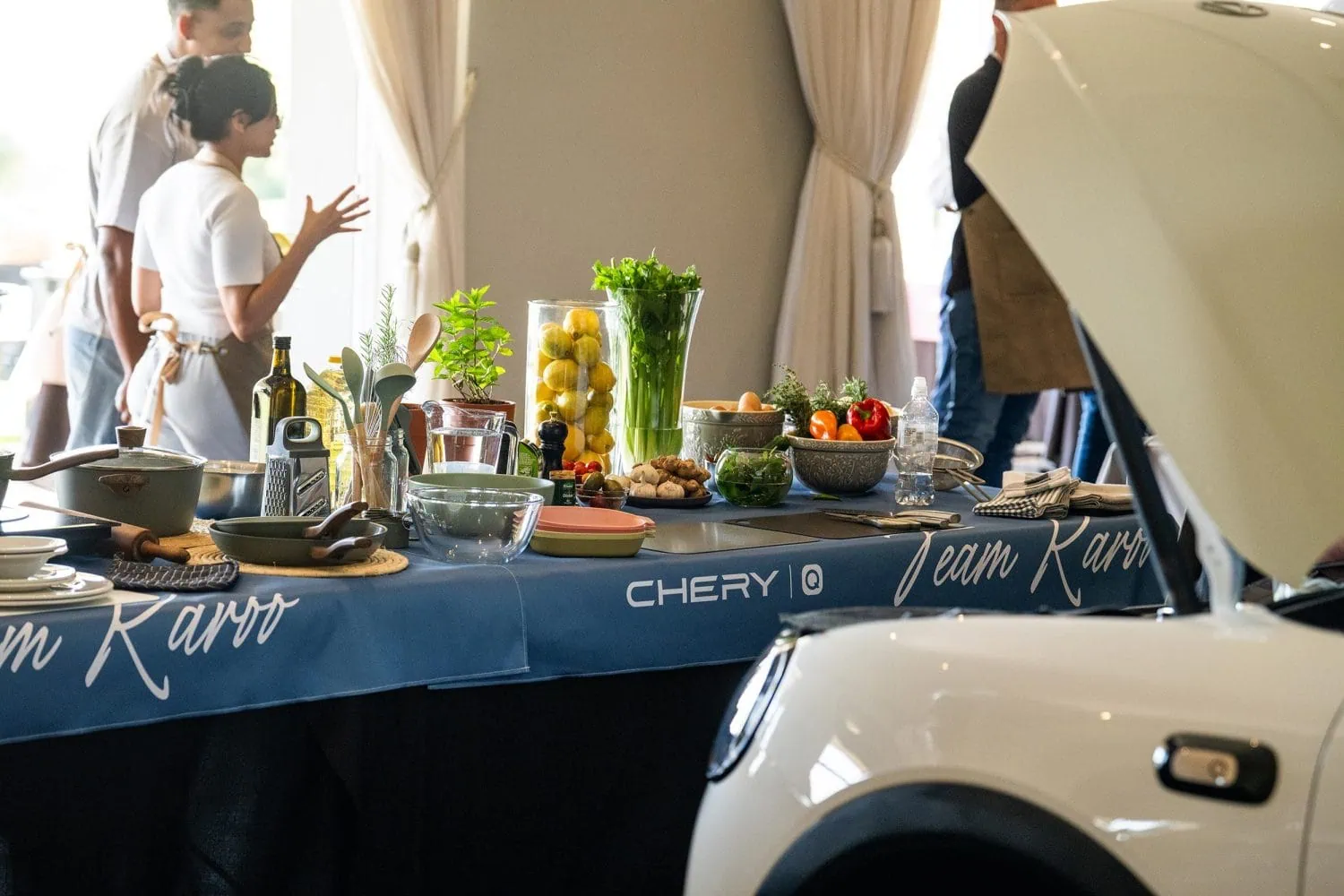 Team Karoo cooking display beside a white Chery Q - Saffarazzi Team Karoo cooking display beside a white Chery Q