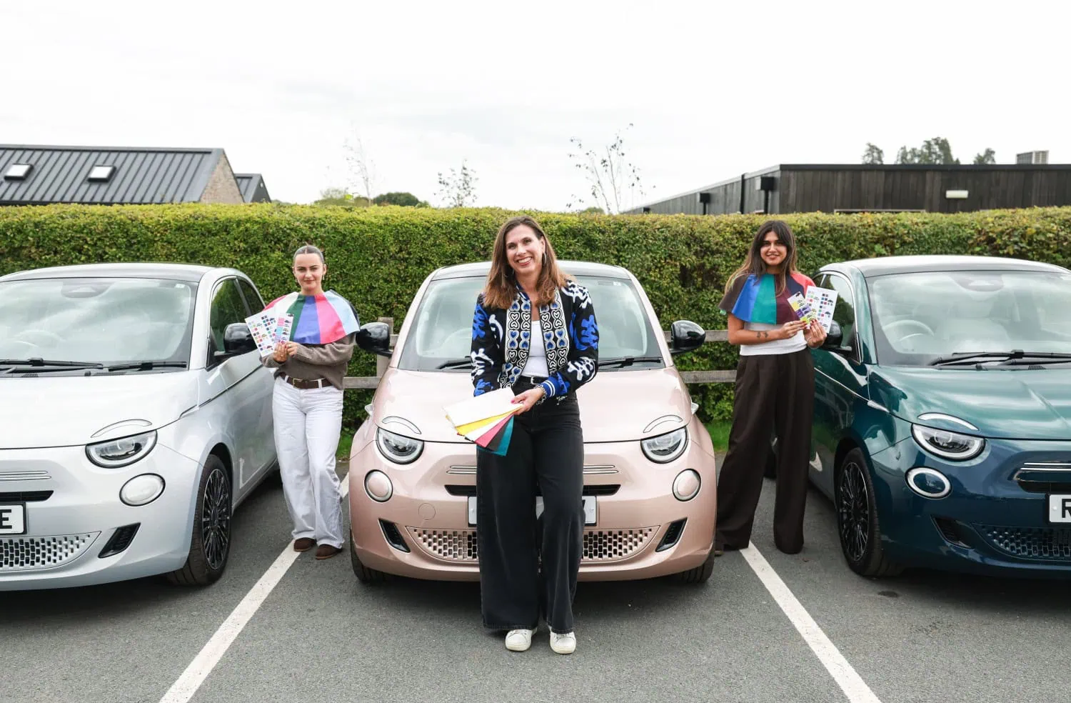 Team with three Fiat 500s - Saffarazzi Three consultants in front of Fiat 500 Hybrid hatchbacks.