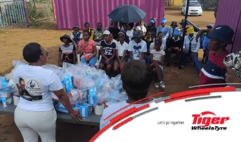 Tiger Wheel & Tyre outreach volunteer addressing seated schoolchildren - Saffarazzi Tiger Wheel & Tyre outreach volunteer addressing seated schoolchildren