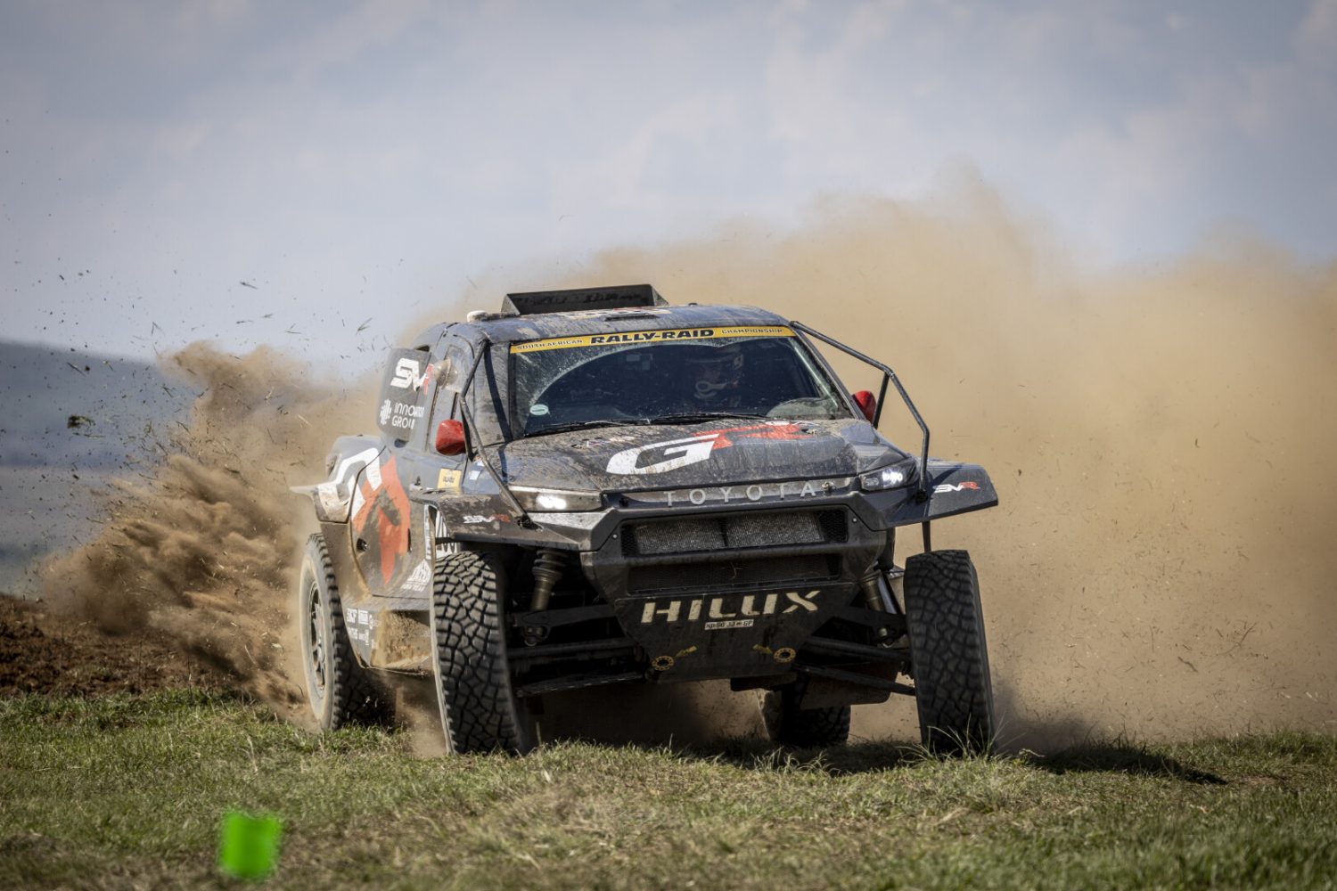 Toyota GR Hilux IMT EVO spraying dirt on open field - Saffarazzi Toyota GR Hilux IMT EVO spraying dirt on open field