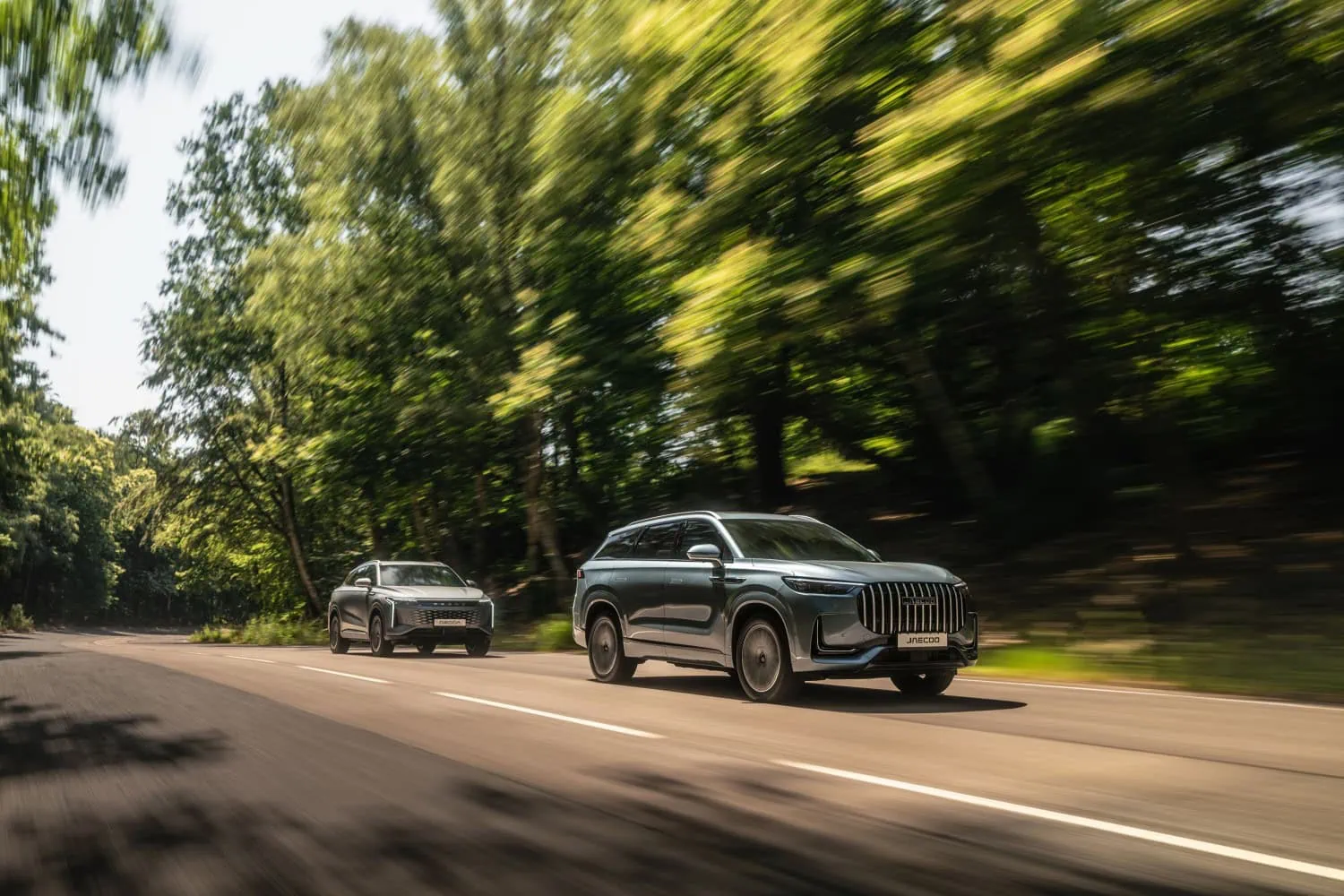 JAECOO SUVs in woodland - Saffarazzi Two JAECOO SUVs driving on a woodland road.