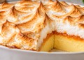 Traditional South African Velvet Pudding (Fluweelpoeding) with golden meringue, apricot jam and creamy baked custard.