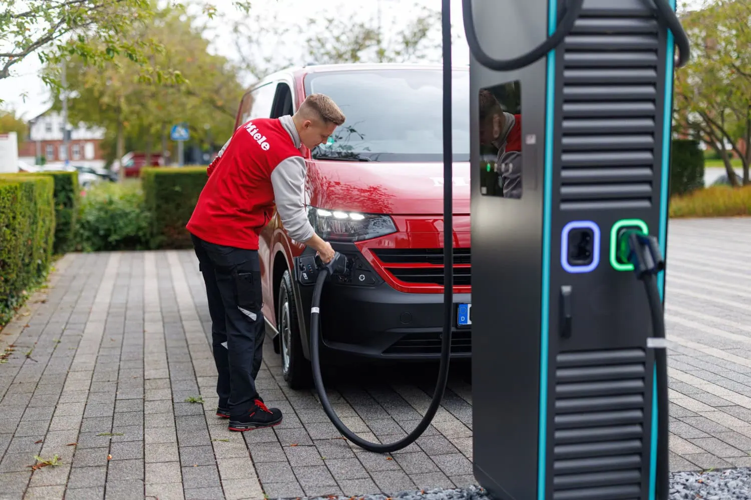 Transporter at charging station - Saffarazzi Volkswagen Transporter electric van charging at fast charger.