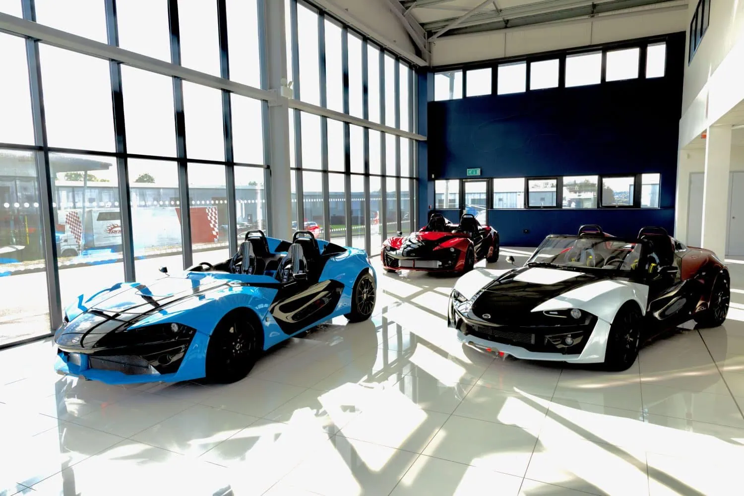 Zenos E10 sports cars in a showroom - Saffarazzi Zenos E10 sports cars in a showroom